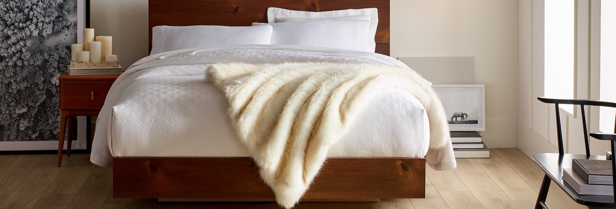 Bedroom with light wood-look luxury vinyl flooring from Carpet Innovations in Denver, CO