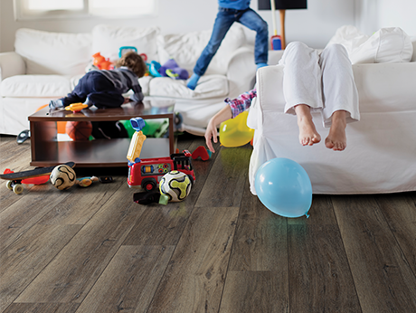 kids playing in room with wood-look laminate flooring from Carpet Innovations in Denver, CO